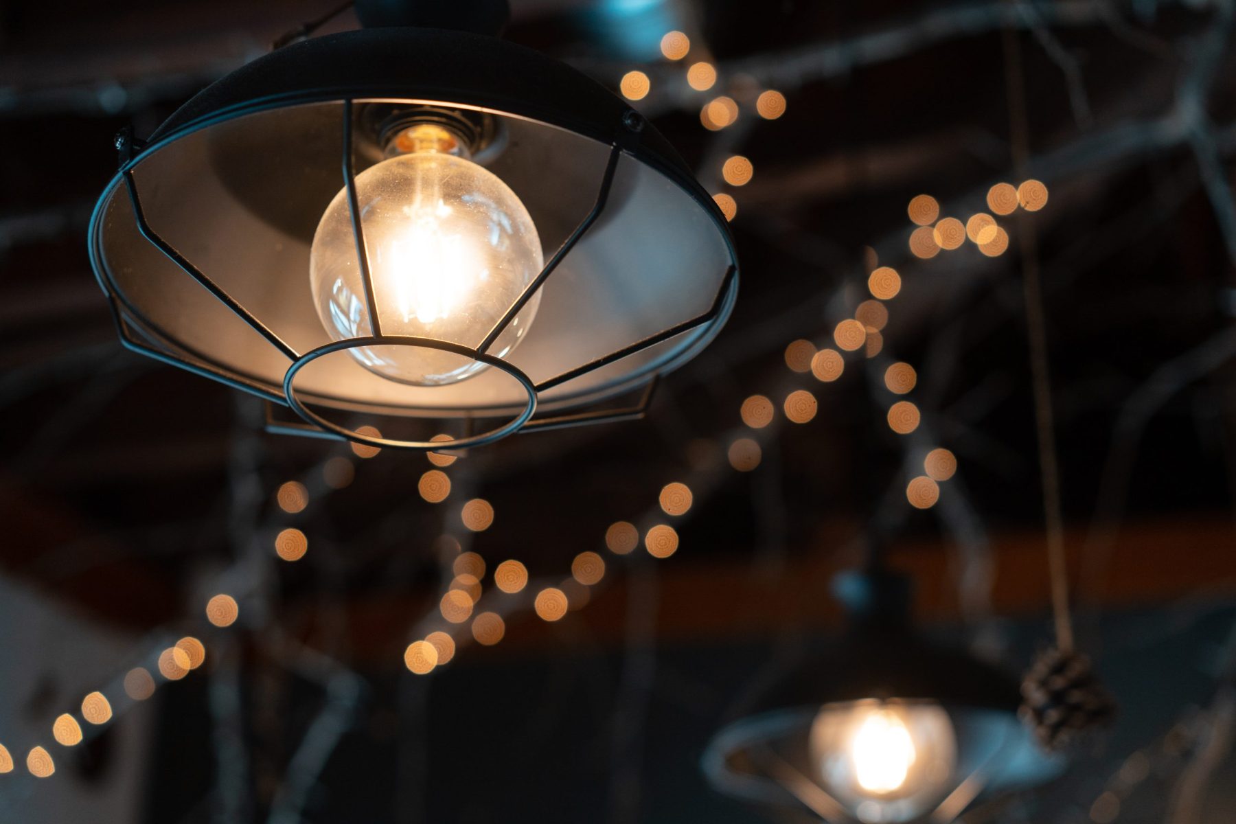 Lamp hanging outside on a dark background.